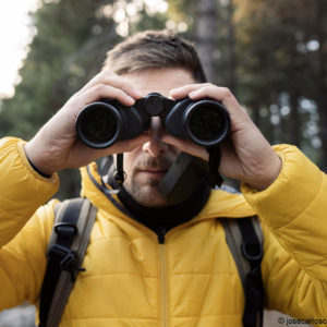 young-traveler-looking-through-binoculars-2023-11-27-05-32-16-utc_WEB_TAG